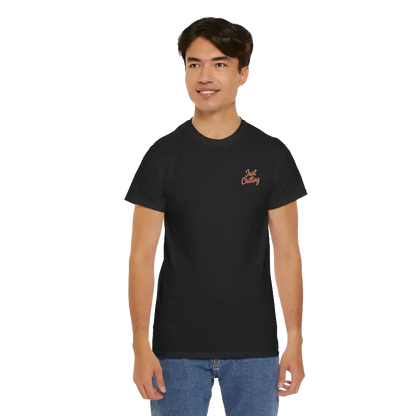 A young man wearing a black t-shirt with a logo on it, smiling at the camera.