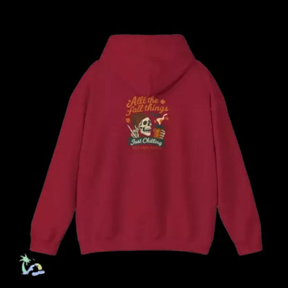 A red hoodie with a graphic design on the back, featuring a skeleton and the text "All the fall things just chilling".