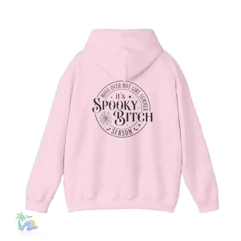 A pink hoodie with a circular design on the back featuring the text "It's Spooky Bitch Season" in a stylized font.