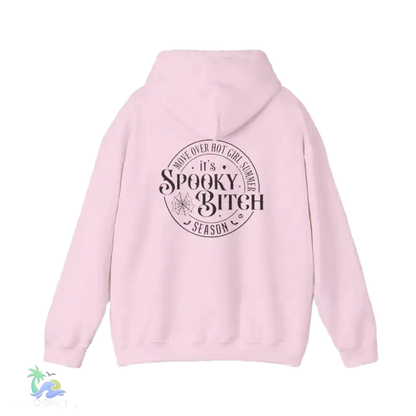 A pink hoodie with a circular design on the back featuring the text "It's Spooky Bitch Season" in a stylized font.