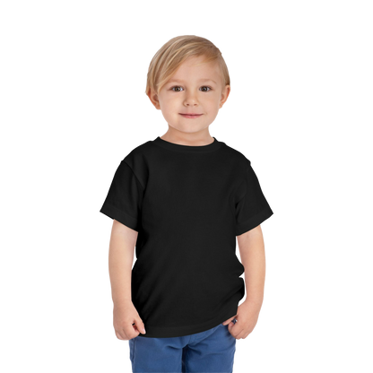 A young boy with blonde hair is smiling and standing against a black background.