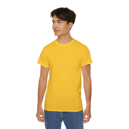 A young man wearing a yellow t-shirt and blue jeans stands against a black background.