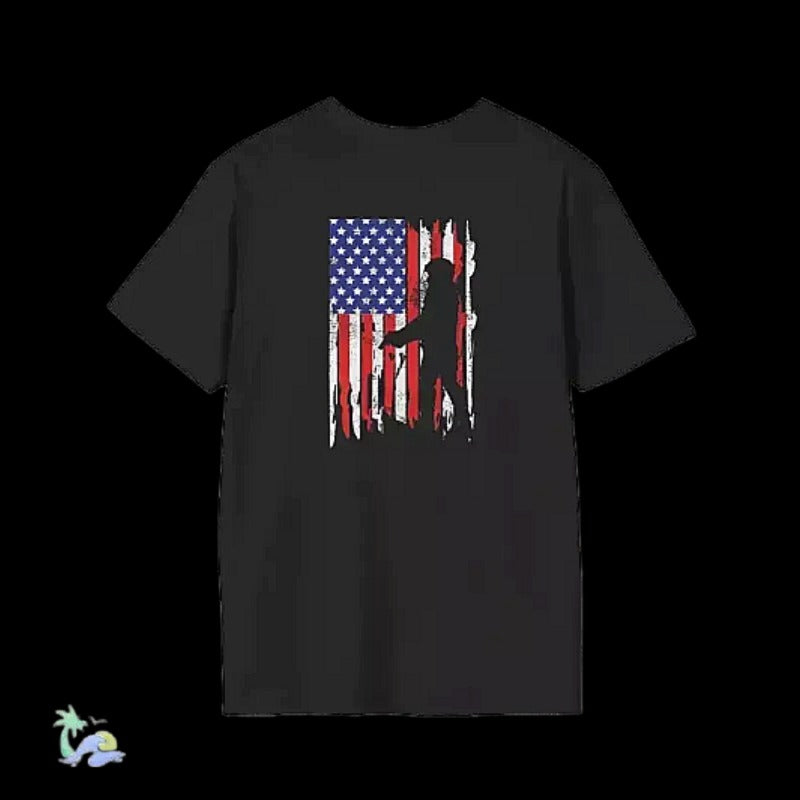 A black t-shirt with a graphic design depicting a silhouetted figure against an American flag.