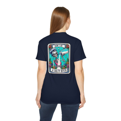 A woman wearing a navy blue t-shirt with a graphic design on the back, featuring a skeleton holding a liquor bottle and the text "Don't be a salty shit".