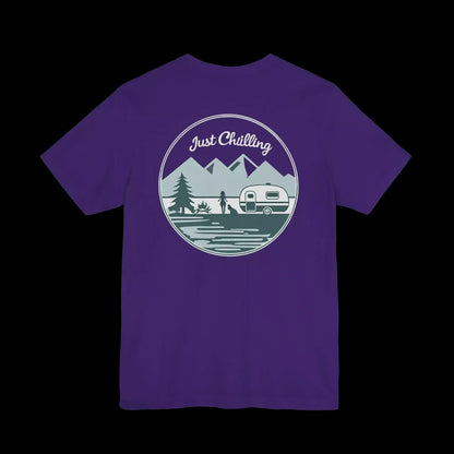 A purple t-shirt with a graphic design featuring a mountain landscape, a camper van, and the text "Just Challenging" in the center.