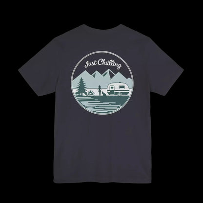 A t-shirt design featuring a circular graphic with a mountain landscape, a camper van, and a person camping. The text "Just Challenging" is written above the graphic.