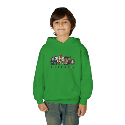 A young boy wearing a green hoodie with a graphic of cartoon characters on it.