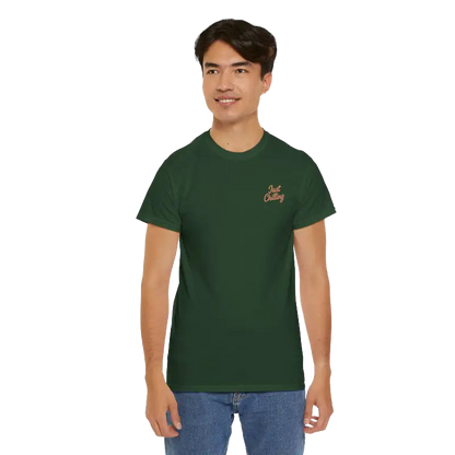 A young man wearing a green t-shirt with a logo on it, smiling at the camera.