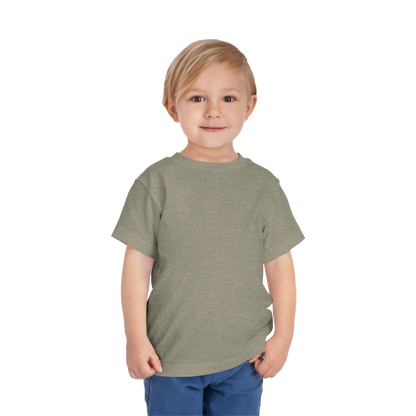 A young boy with blonde hair is smiling and standing against a black background.
