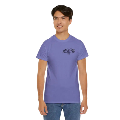 A young man wearing a purple t-shirt with a logo on it, smiling at the camera.