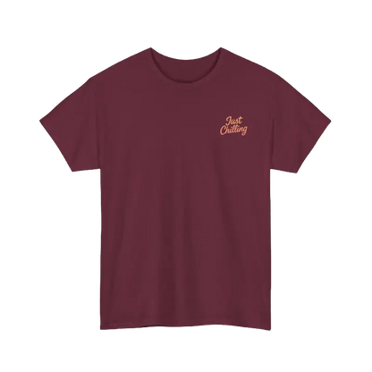 A maroon t-shirt with a small embroidered logo on the left side that says "Just Chilling".