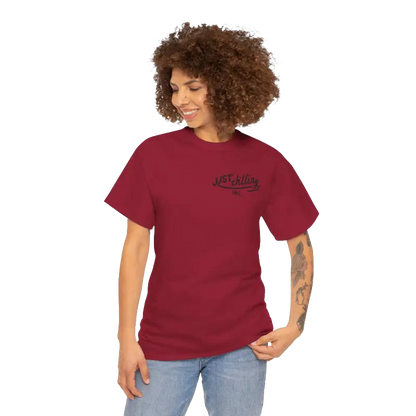 A smiling woman with curly hair wearing a red t-shirt with the text "JUST KILLING INC." printed on it.