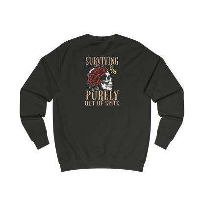 A black sweatshirt with a graphic design on the back featuring a skull with a rose and the text "Surviving Purely Out of Spite".
