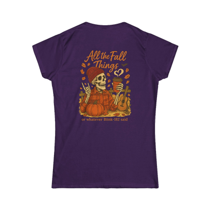 A purple t-shirt with an illustration of a skeleton holding a cup and a pumpkin, surrounded by autumn leaves and a heart. The text on the back of the t-shirt says "All the Fall Things or whatever Blik 182 said".