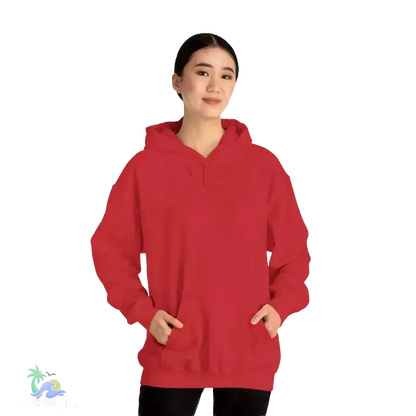A woman wearing a red hoodie stands against a black background.