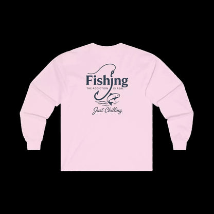 A pink long-sleeved shirt with a graphic design on the back, featuring the text "Fishing is the addiction. Just chilling."