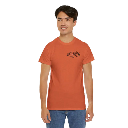 A young man wearing an orange t-shirt with a logo on it, smiling at the camera.