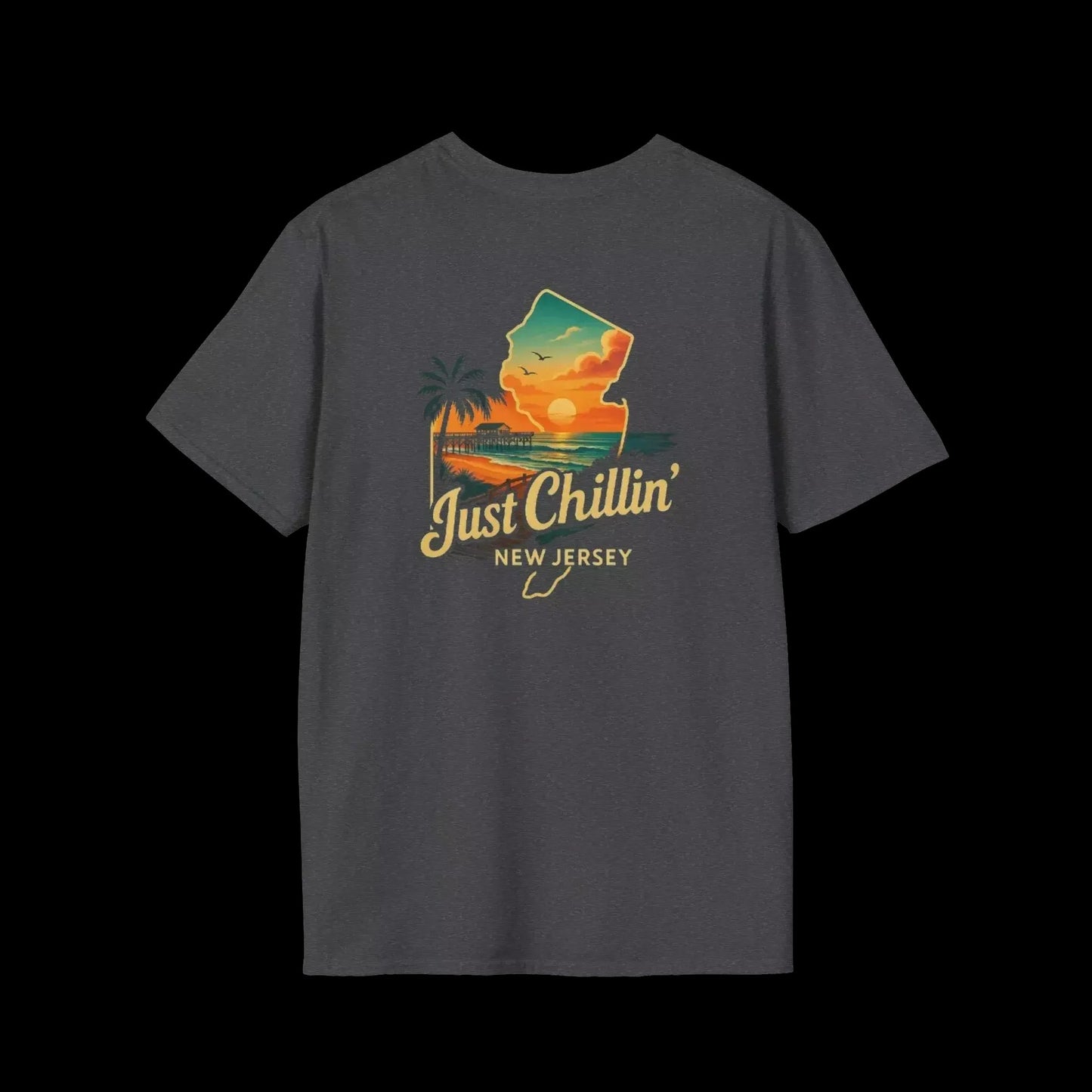A gray t-shirt with a graphic design depicting a sunset over a beach and palm trees, along with the text "Just Chillin' NEW JERSEY".