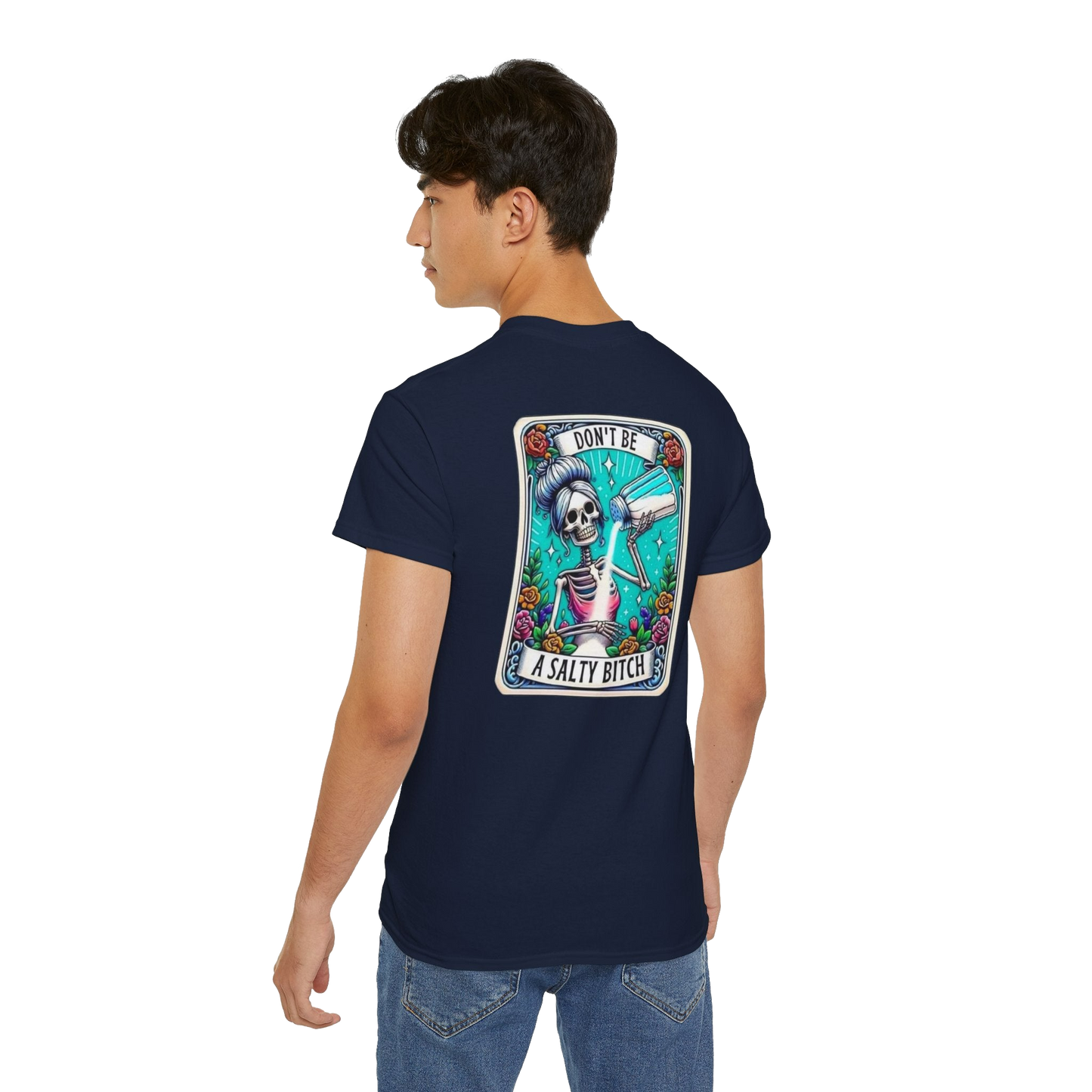 A person wearing a navy blue t-shirt with a graphic design on the back, depicting a skeleton holding a sombrero and the text "Don't be a salty butt".