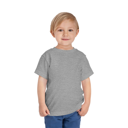 A young boy with blonde hair is smiling and standing against a black background.