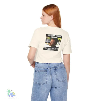 Woman wearing a cropped t-shirt and jeans.