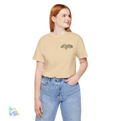 Woman wearing a tan t-shirt and blue jeans.