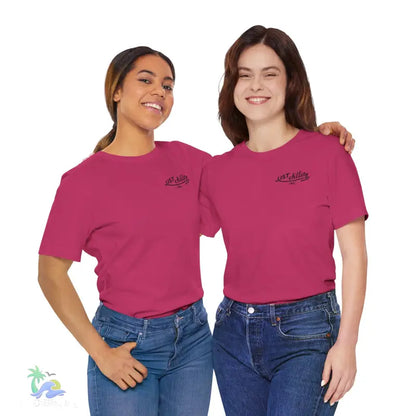 Two women wearing matching pink t-shirts and jeans.