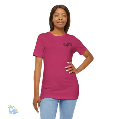 Woman wearing a magenta t-shirt and jeans.