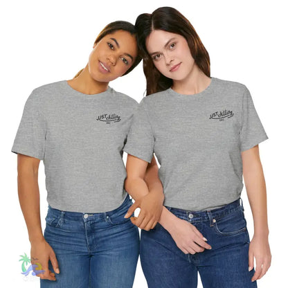 Two women wearing gray t-shirts and jeans.