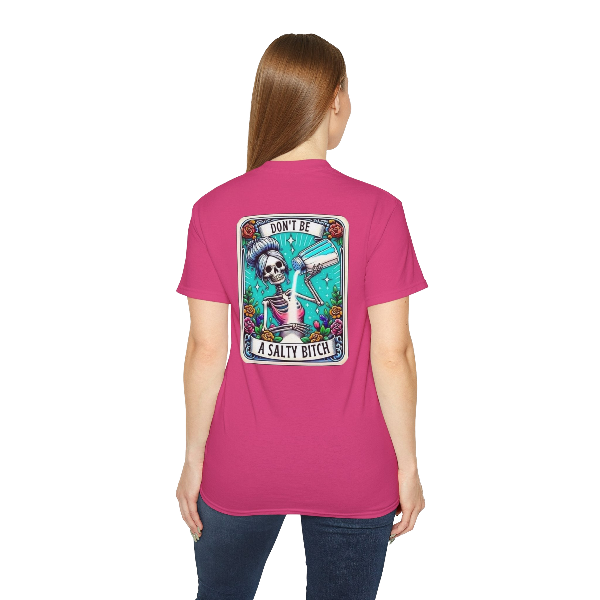 A woman wearing a pink t-shirt with a graphic design on the back.