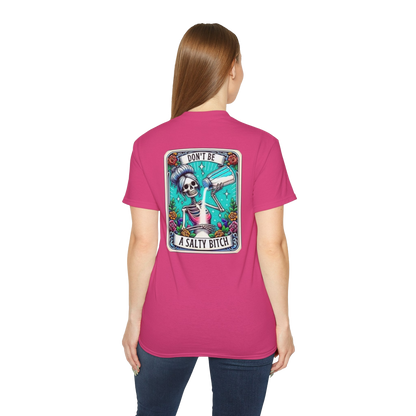 A woman wearing a pink t-shirt with a graphic design on the back.
