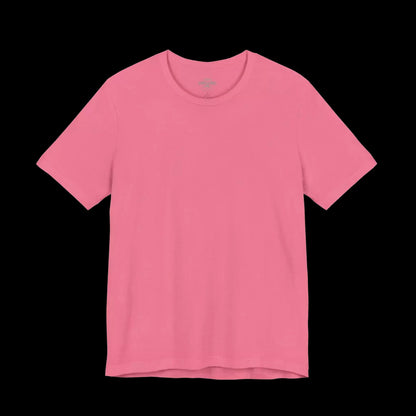 A plain, solid pink t-shirt against a black background.
