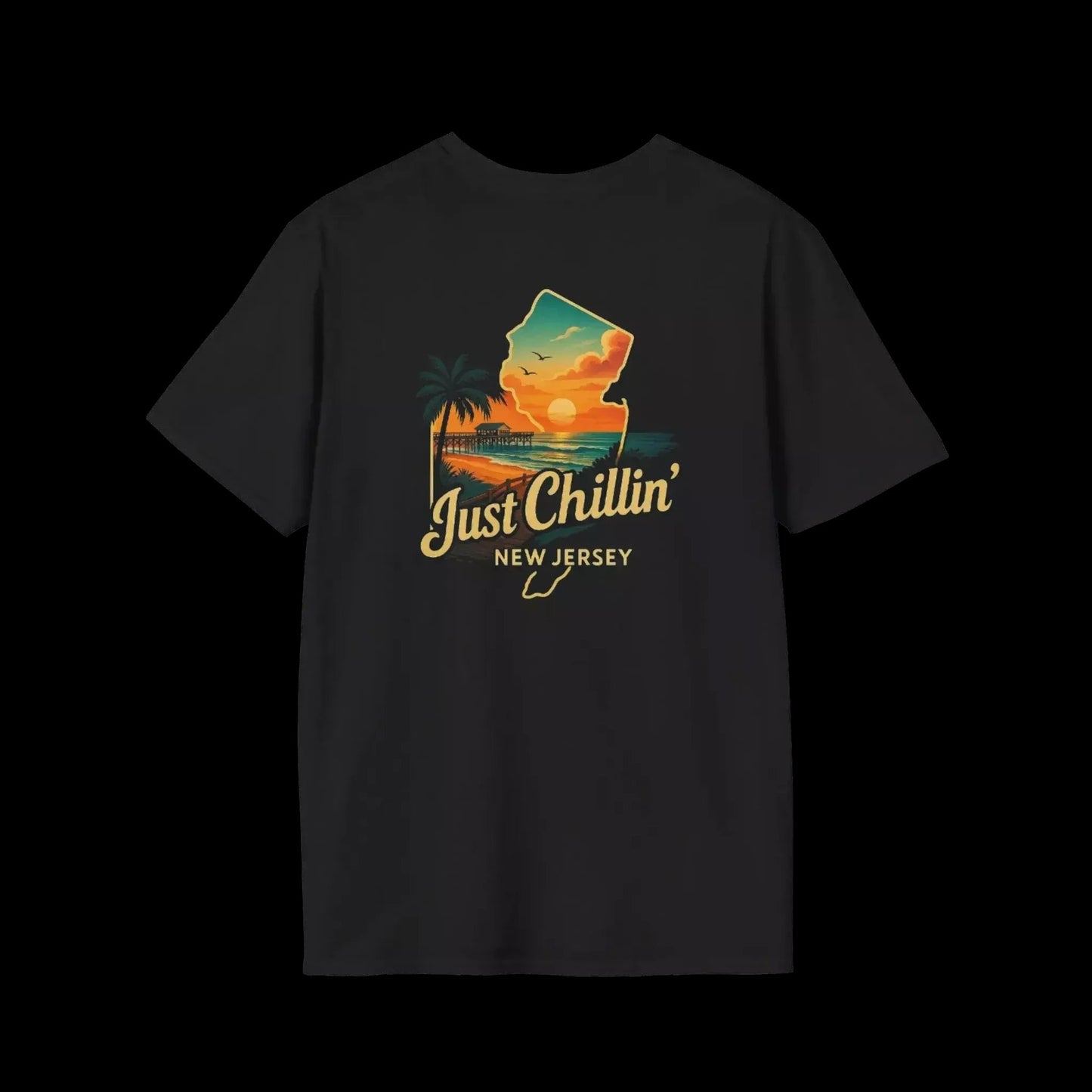 A black t-shirt with a graphic design depicting a sunset over a beach and palm trees, along with the text "Just Chillin' NEW JERSEY".