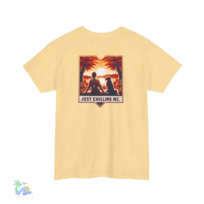 A yellow t-shirt with a graphic design depicting a person sitting in a relaxed pose with a dog, and the text "JUST CHILLING NC" below the image.