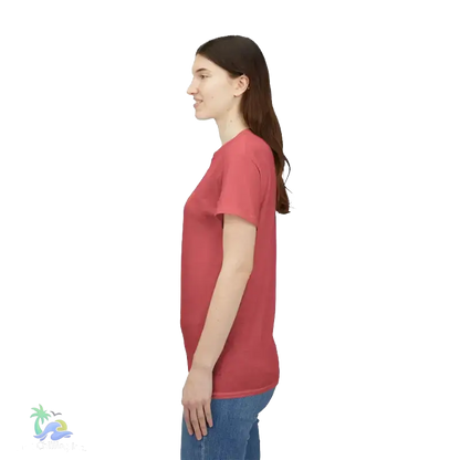 A woman wearing a red t-shirt stands against a black background.