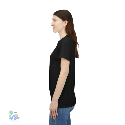 A woman with long brown hair is standing in profile, wearing a black t-shirt and blue jeans.