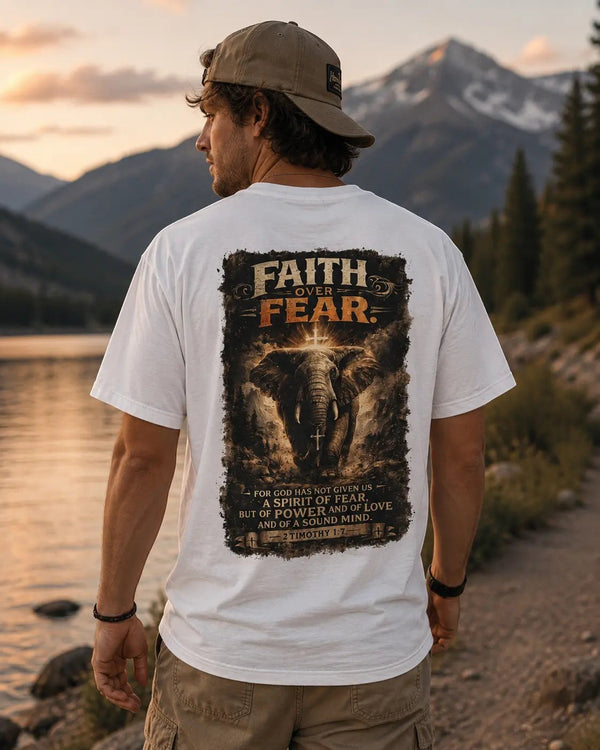 Just Chilling Shop white cotton t-shirt featuring a back graphic of an elephant and Faith Over Fear text by a lake.