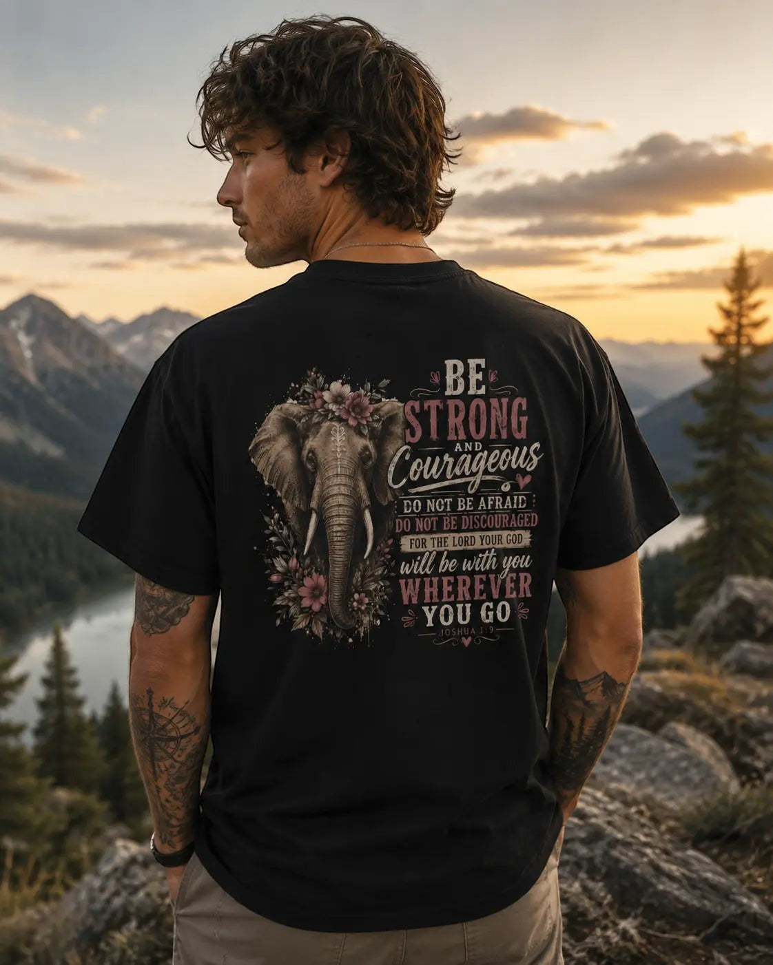 Just Chilling Shop black graphic t-shirt featuring an elephant and inspirational quote worn by a man in the mountains.