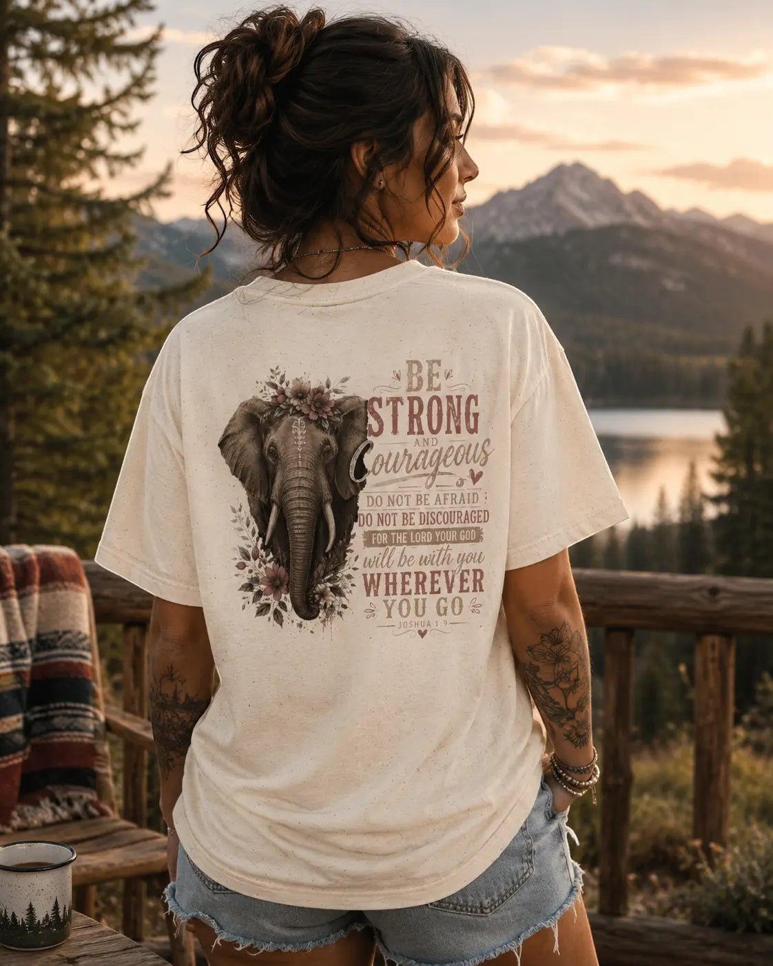 Just Chilling Shop cream cotton t-shirt with a vintage elephant and floral graphic print, worn by a woman outdoors.