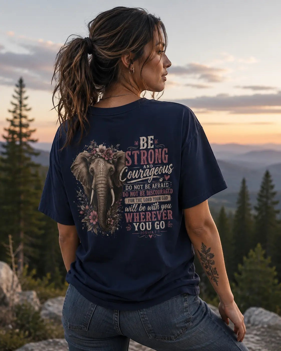Woman wearing a navy Just Chilling Shop cotton t-shirt with a floral elephant graphic and inspirational text on the back