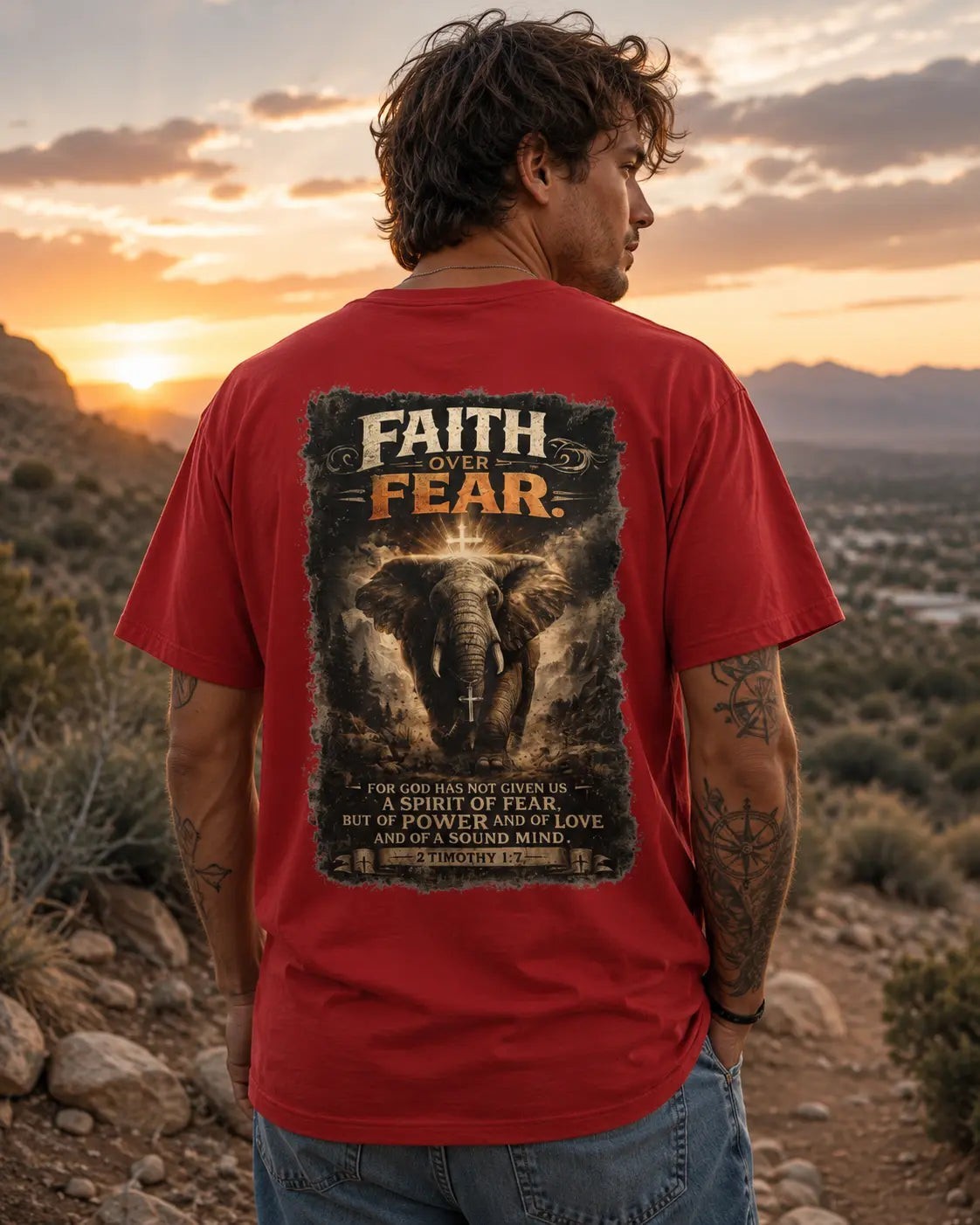 Just Chilling Shop red cotton t-shirt with back graphic of an elephant and Faith Over Fear text at sunset
