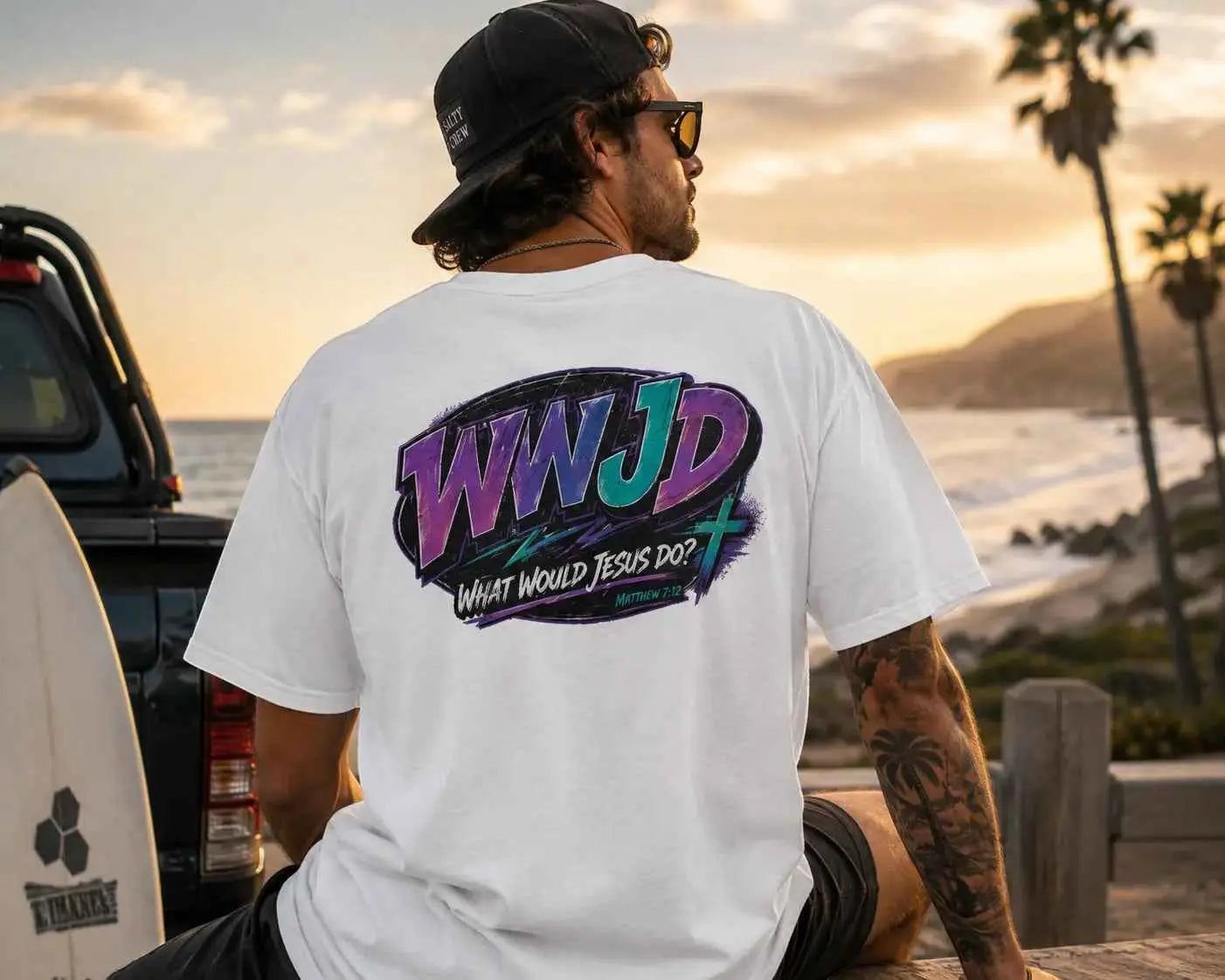 Just Chilling Shop white cotton graphic tee with retro 90s style WWJD back print in purple and teal worn by a man