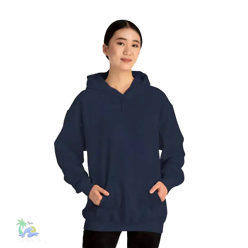 A woman wearing a navy blue hoodie stands against a black background.