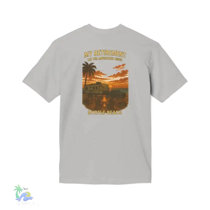 A white t-shirt with a graphic design depicting a sunset scene with palm trees and a vehicle in the background.