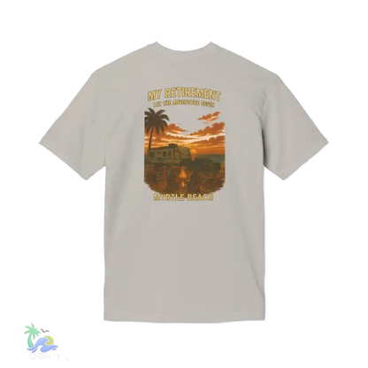 A t-shirt with a graphic design depicting a sunset scene with palm trees and a vehicle, along with the text "MY RETIREMENT" and "MY ADVENTURE BEGIN".