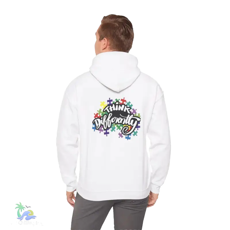A person wearing a white hoodie with a colorful graphic and text on the back.