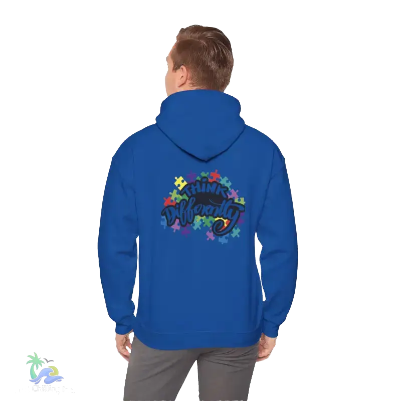 A person wearing a blue hoodie with a colorful graphic design on the back.
