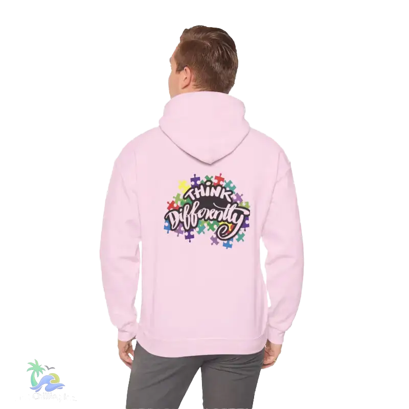 A person wearing a pink hoodie with a colorful graphic and text on the back.