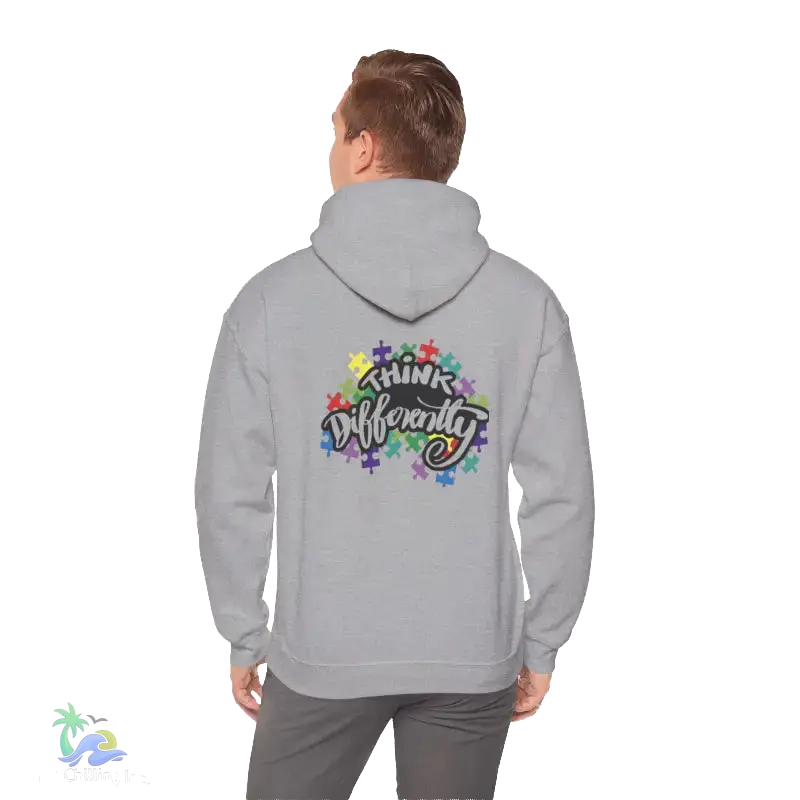 A person wearing a grey hoodie with a colorful graphic and text on the back.