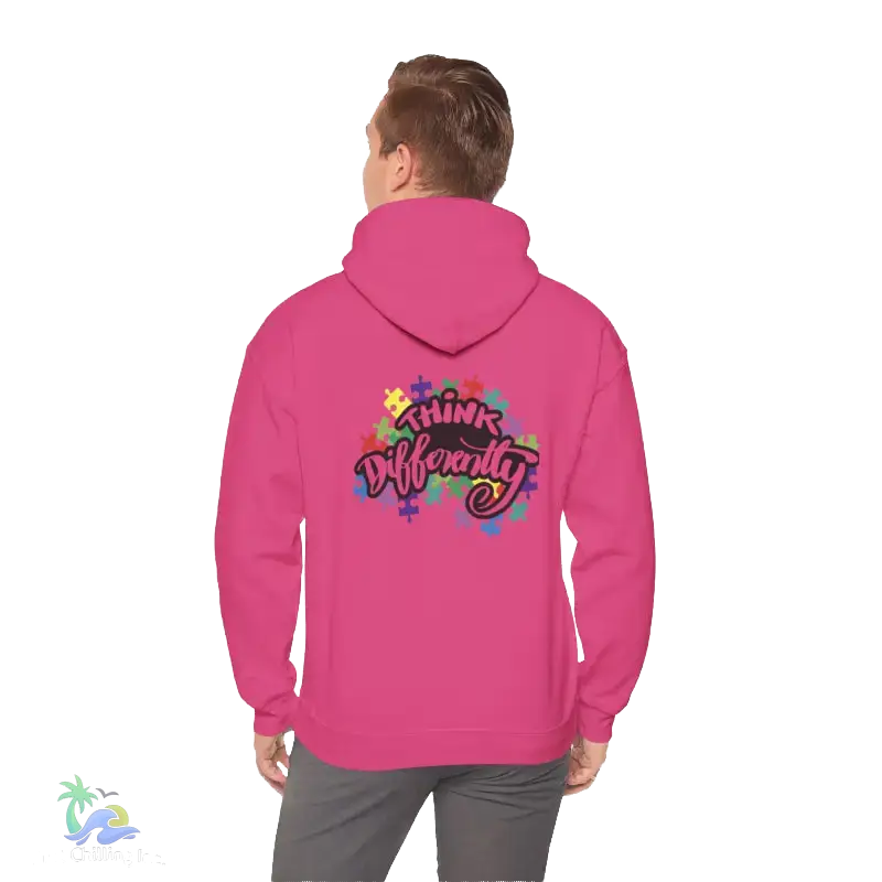 A person wearing a pink hoodie with a colorful graphic and text on the back.